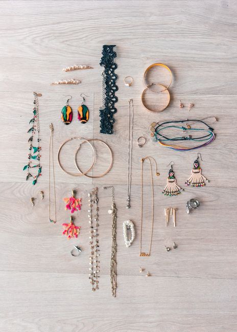 Various elegant jewelry pieces arranged in a boho flat lay style