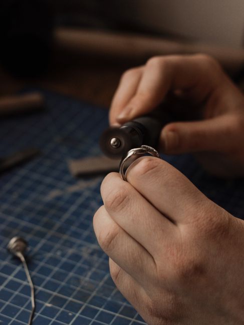 Close-up of a craftsman polishing a silver ring