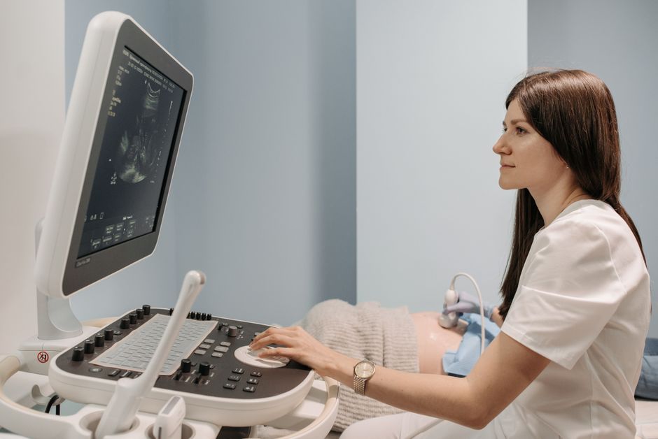 A female doctor conducting an ultrasound examination in a medical clinic