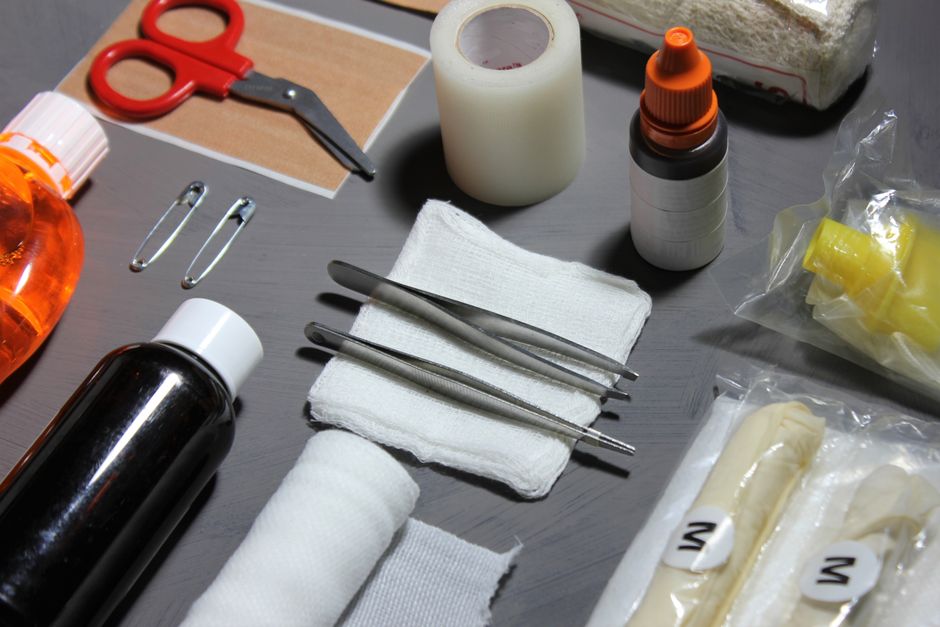 First aid items including bandages, gauze, scissors, and disinfectants