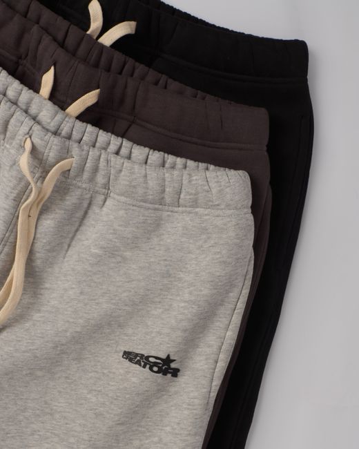 Top-down view of folded sweatpants in various colors