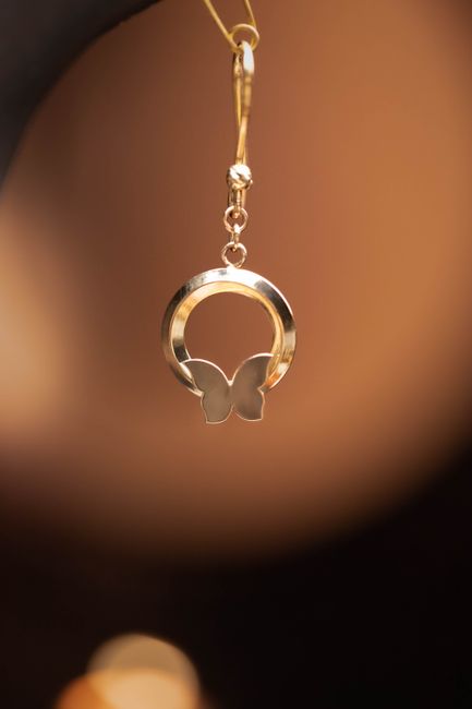 Closeup of a golden butterfly pendant charm