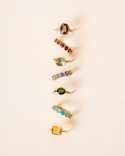 Collection of gold rings featuring diverse colorful gemstones