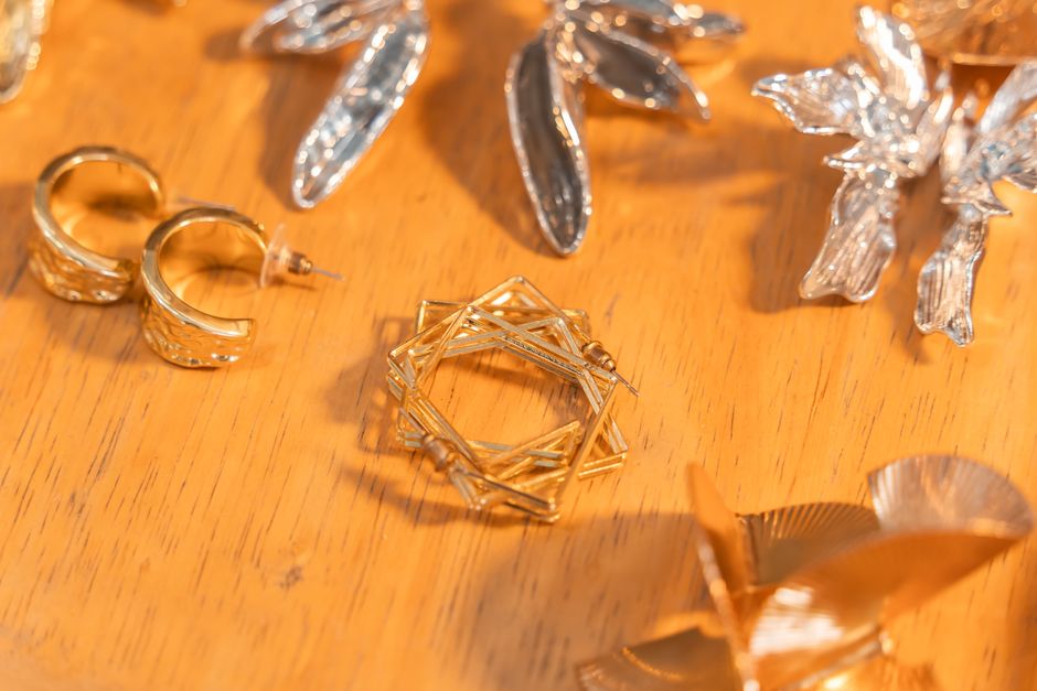 Close-up of elegant gold and silver earrings side by side
