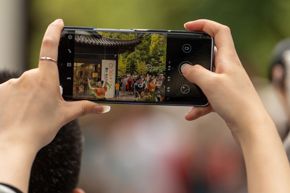 Hands holding a smartphone taking a photo