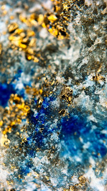 Detailed close-up of a vibrant mineral with iridescent blue and gold textures