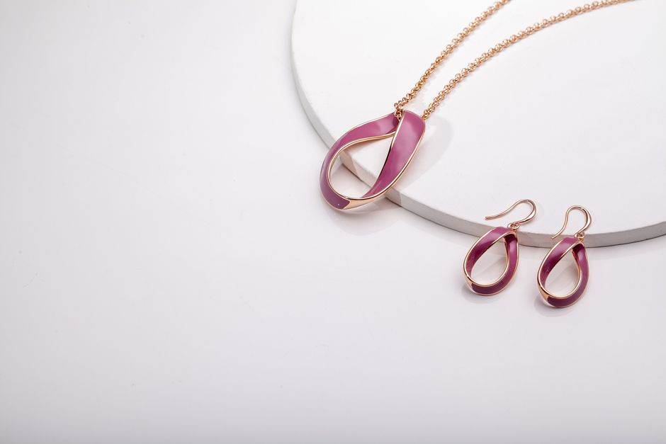 Stylish rose gold jewelry set displayed on a white surface