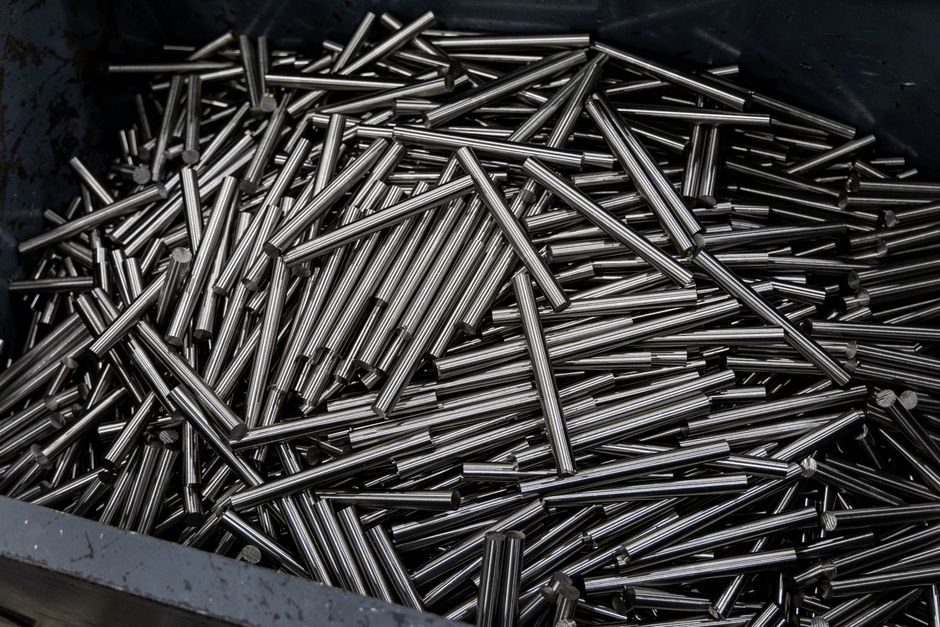 Close-up of numerous stainless steel rods in a container