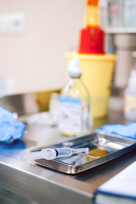 Close-up of a sterile syringe on a clinical tray