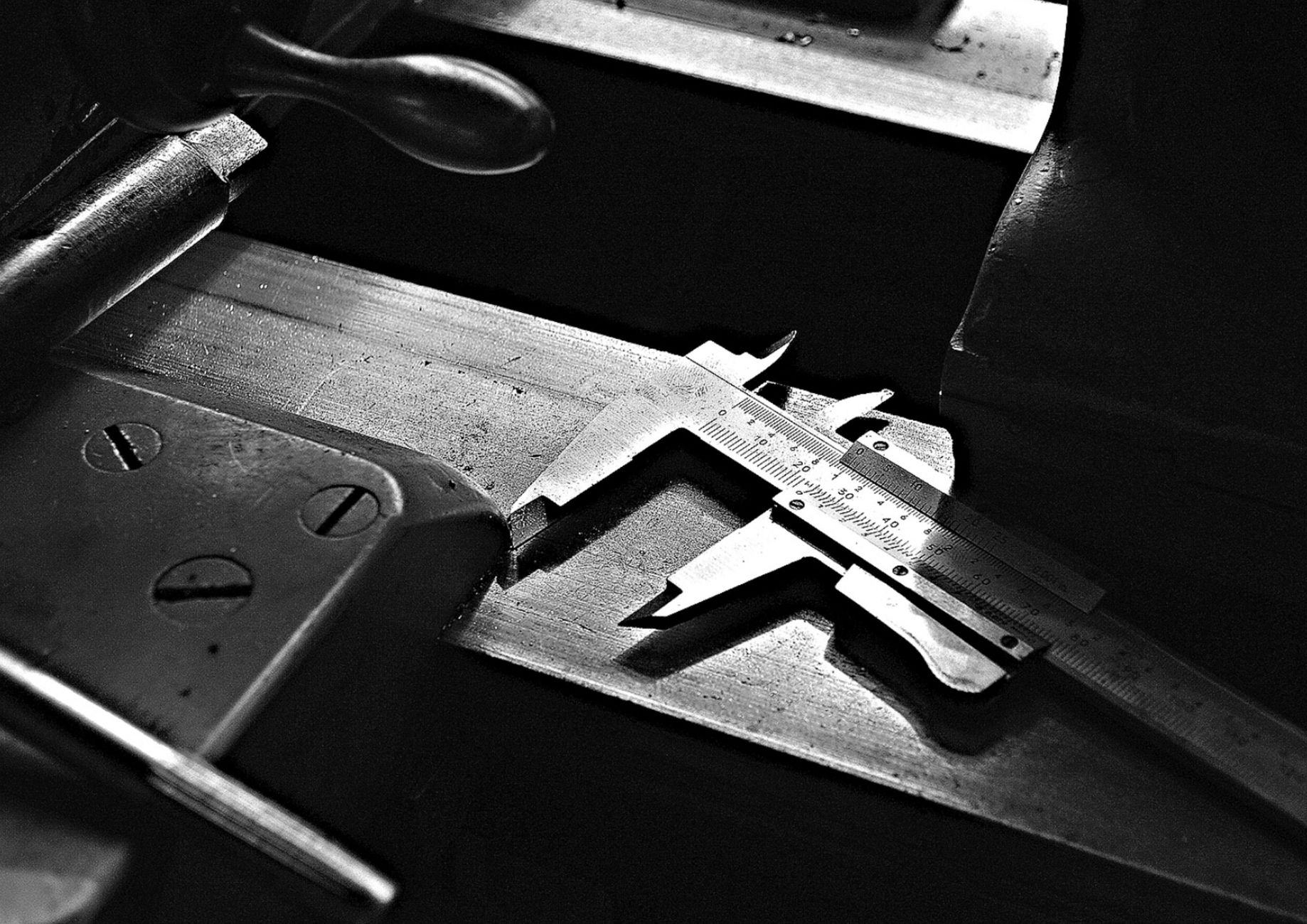 Vintage caliper tool resting on a workbench