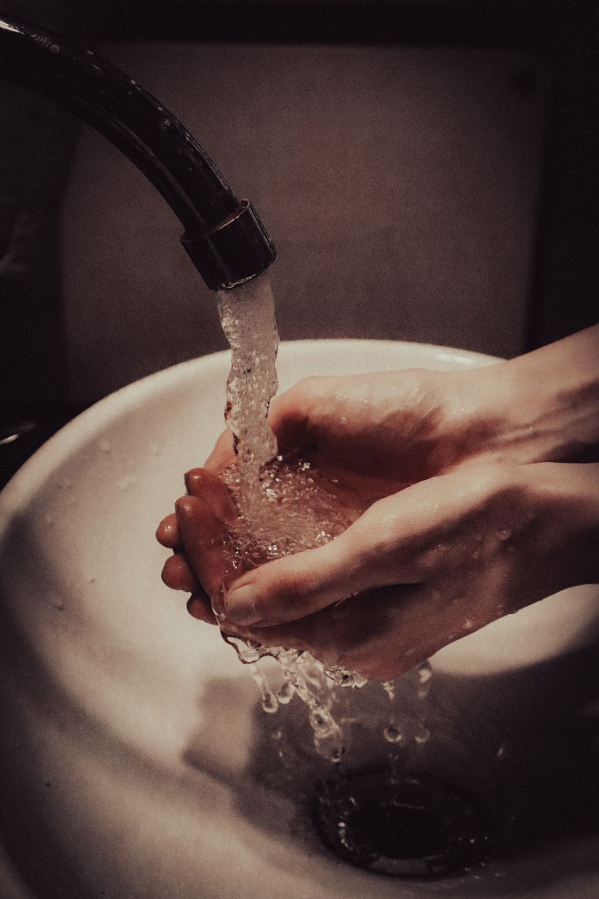 Washing hands under running water before handling piercing jewelry